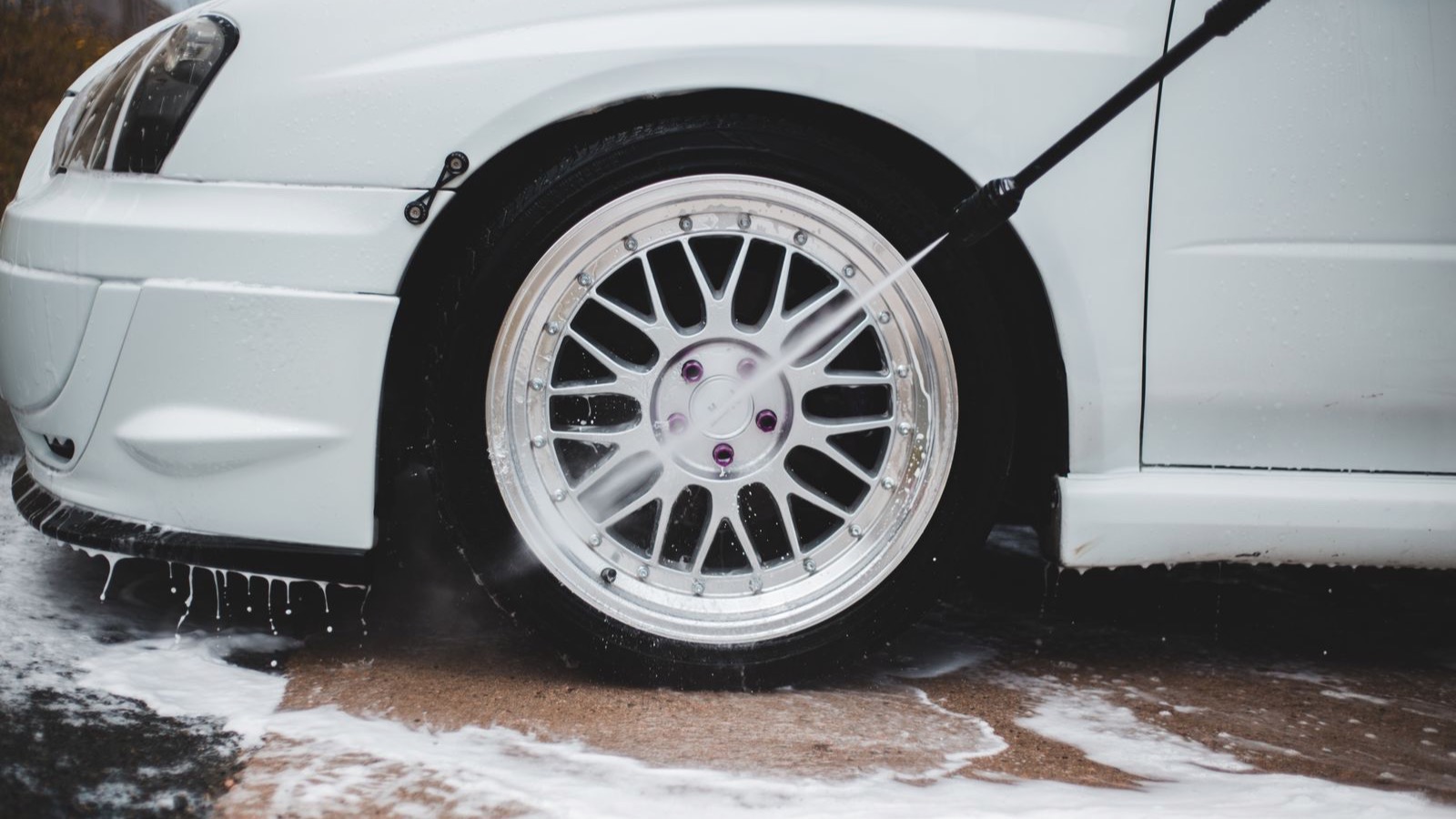 A wheel being cleaned by hand with soap suds